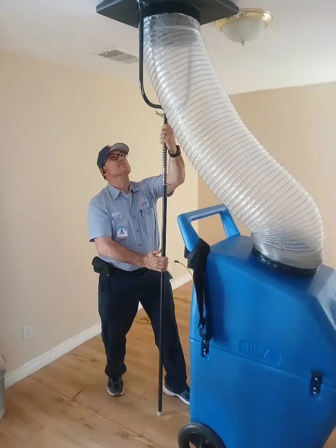 Furnace Tune-Up technician using HEPA equipment in Aurora
